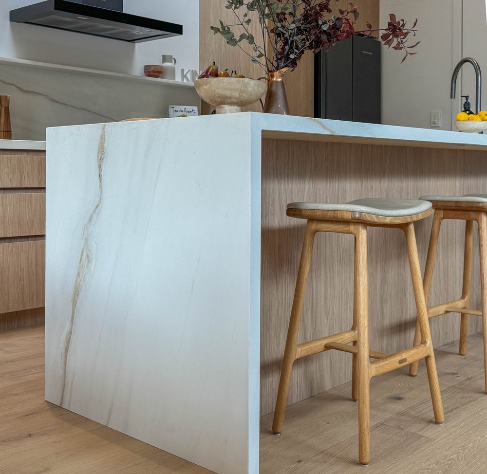 Stone waterfall island with timber counter stools
