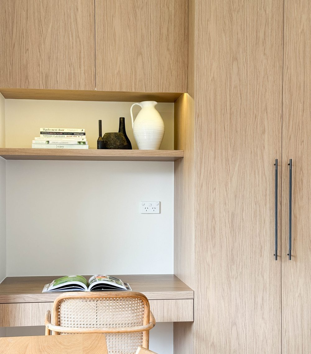 Integrated study nook with timber joinery and rattan chair